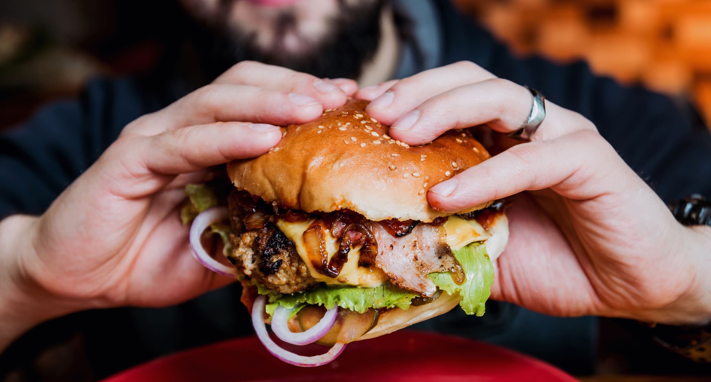 Man eating a cheeseburger.