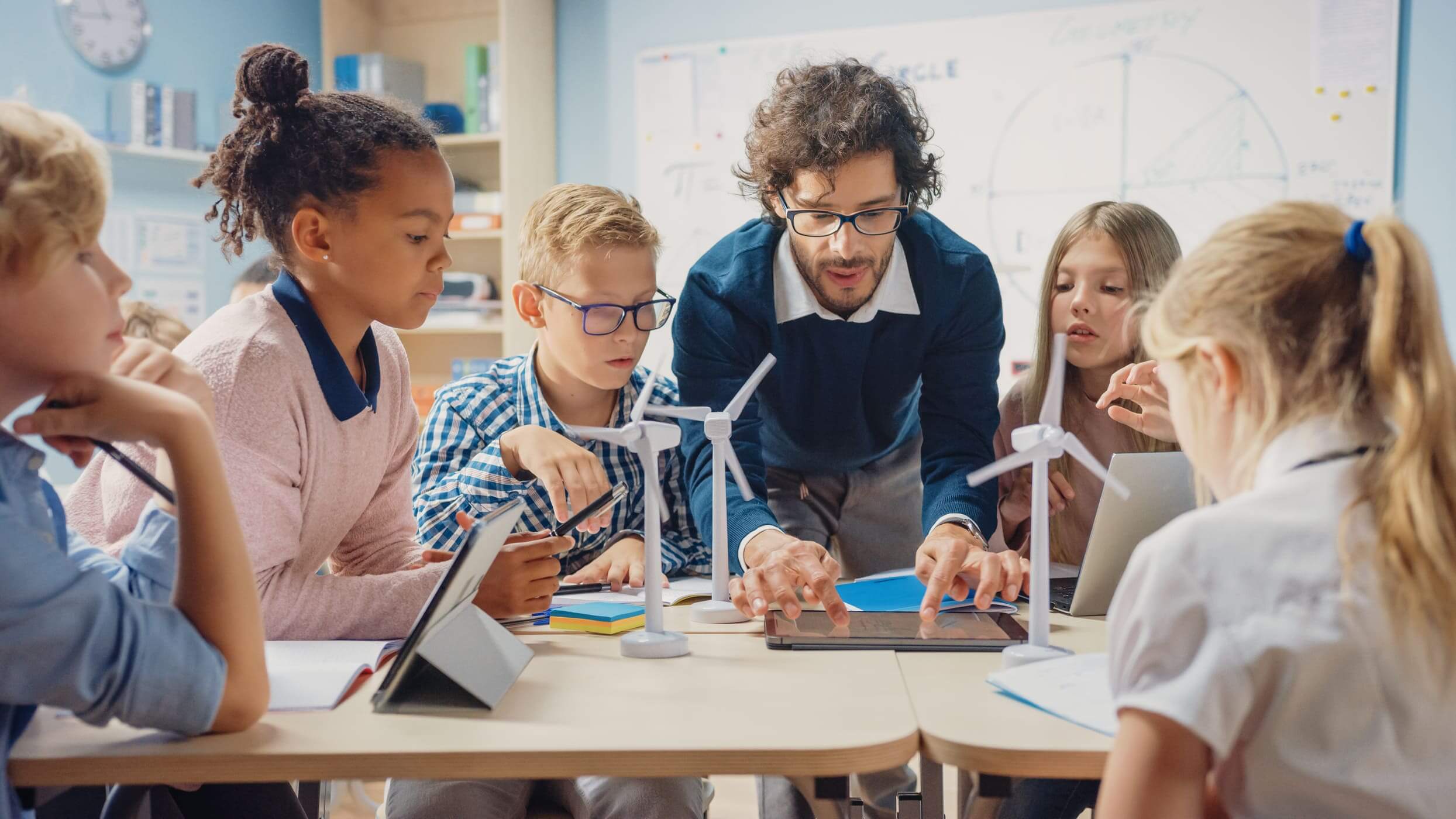 Teacher helping elementary students