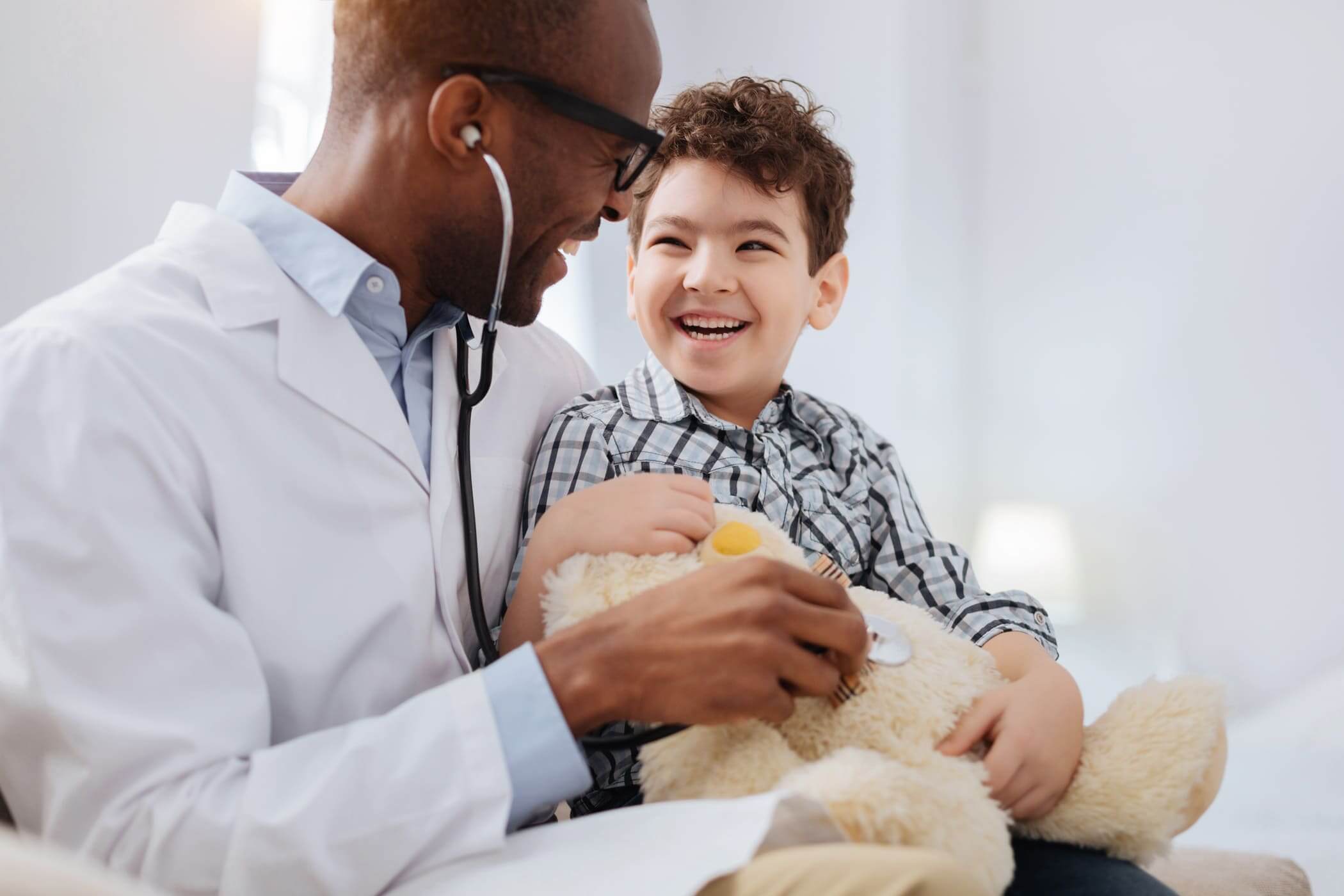 Doctor with child and stuffed bear