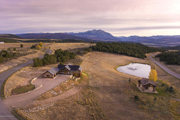 An aerial view of 47 Callicotte Ranch Drive, Carbondale, CO, with a mountain landscape in the background.