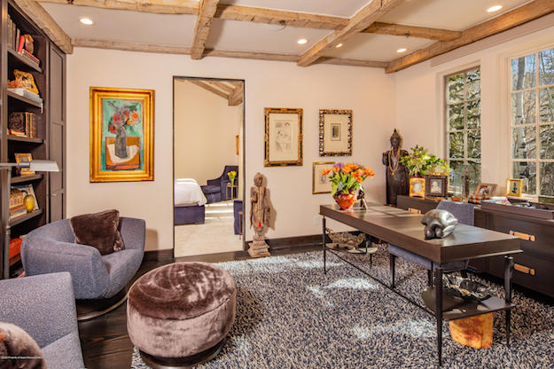 A home office and library in Aspen, Colorado, with a wood-beamed ceiling. 