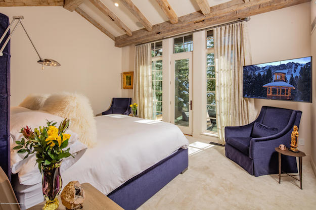 A spacious master bedroom suite in Aspen, Colorado, located on the main level.