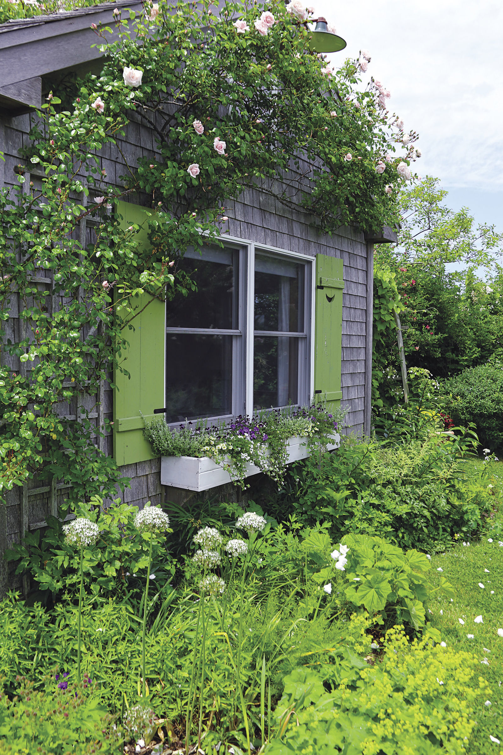 The walls of each cottage serve two purposes: They help shelter tender plants from punishing winds, and they provide a structure for an array of climbing vines.