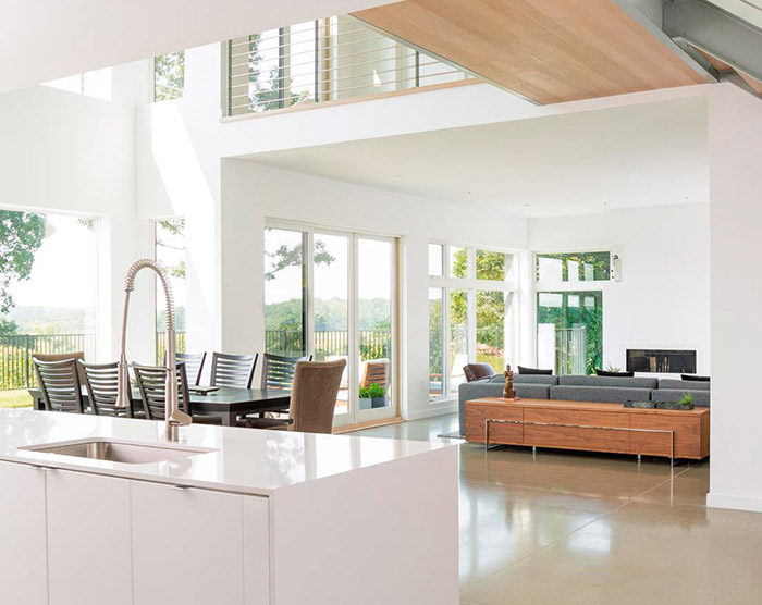 Outside greenery provides just enough background color to enhance a contemporary open floor plan dominated by cool whites and grays.