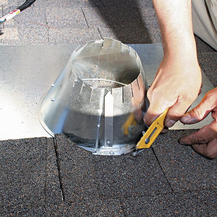3  With the vent in place, trim the shingles to fit the upper arc of the vent.