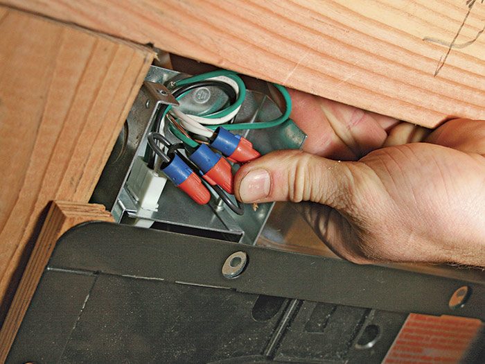 4  Fold the spliced wires into the junction box and install the cover.