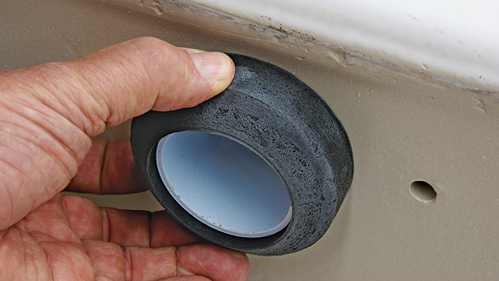 Push the foam seal over the threads