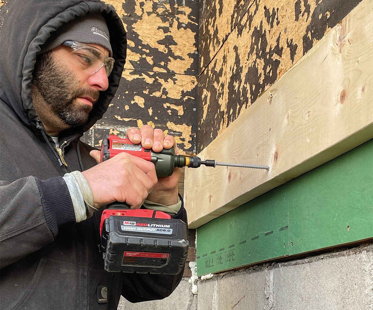 installing new mudroom floor starting with 2x8 ledgers fastened with structural screws