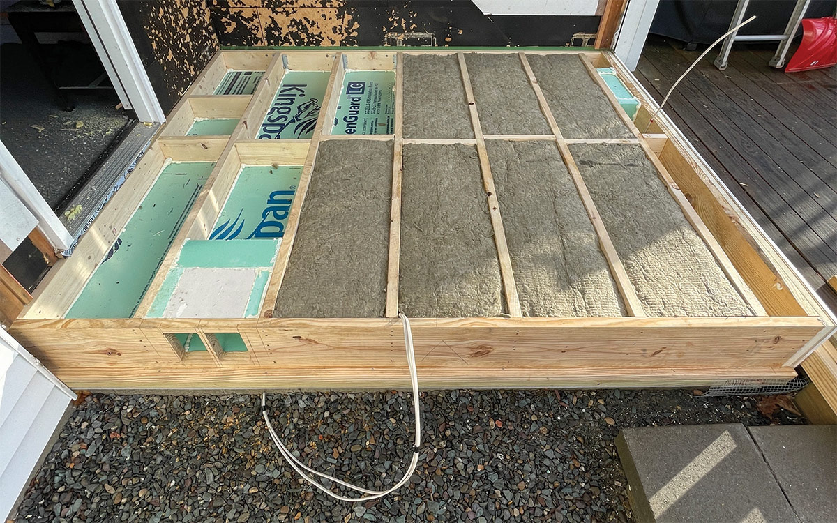 framing of new mudroom floor with cables running under the floor