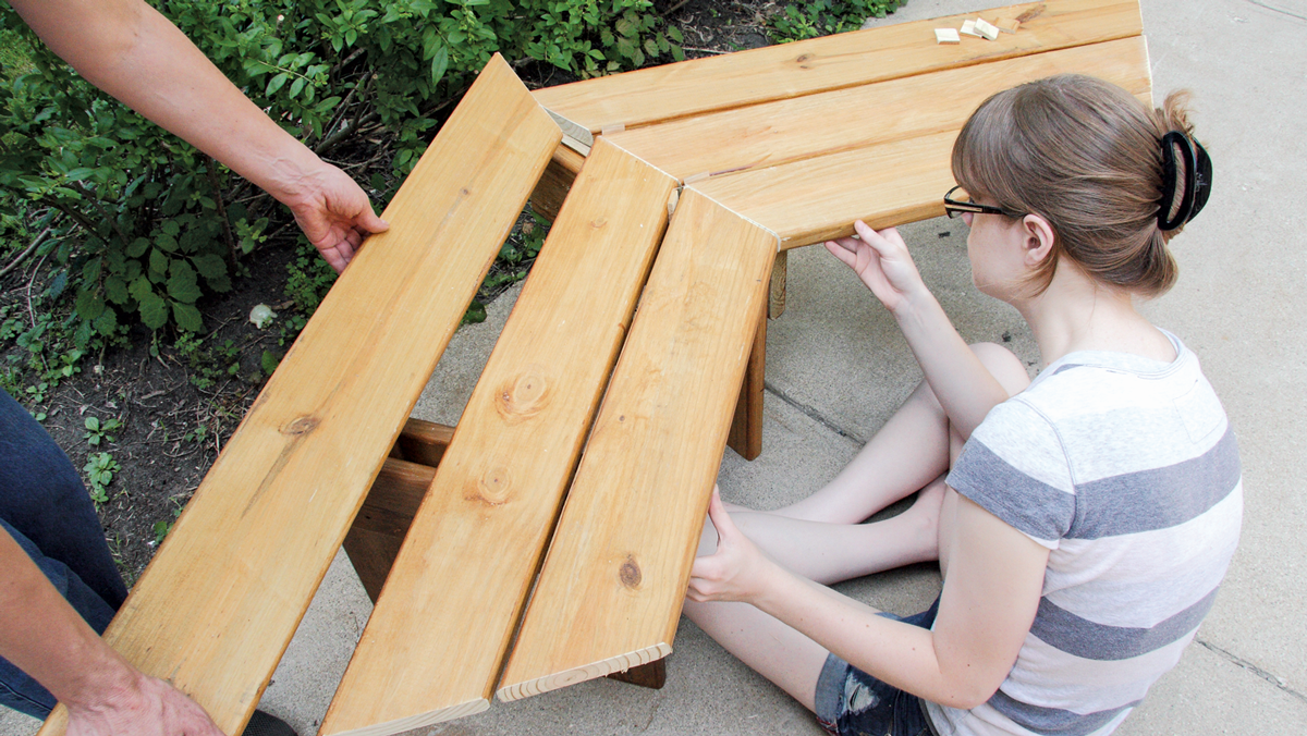 Working on a flat surface, start assembling; this is much easier with a helper or two.