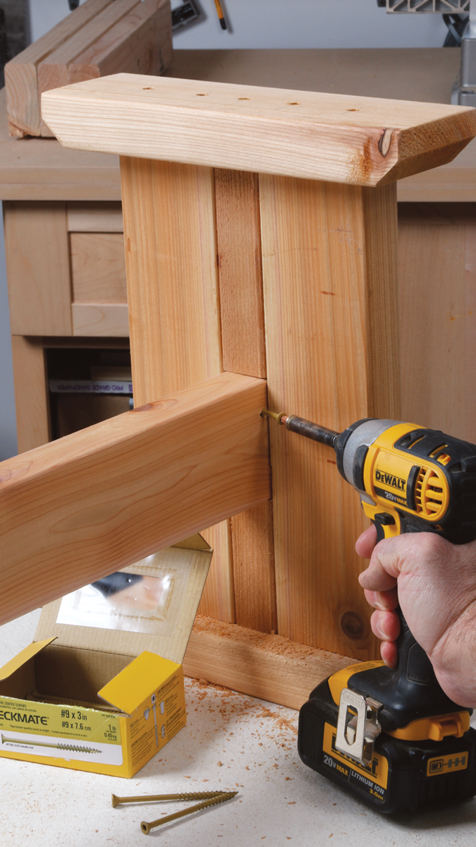 Drill clearance holes on the inside corners of the beam, at a sharp angle so the screws will pass into the trestle. Do one hole on each side.