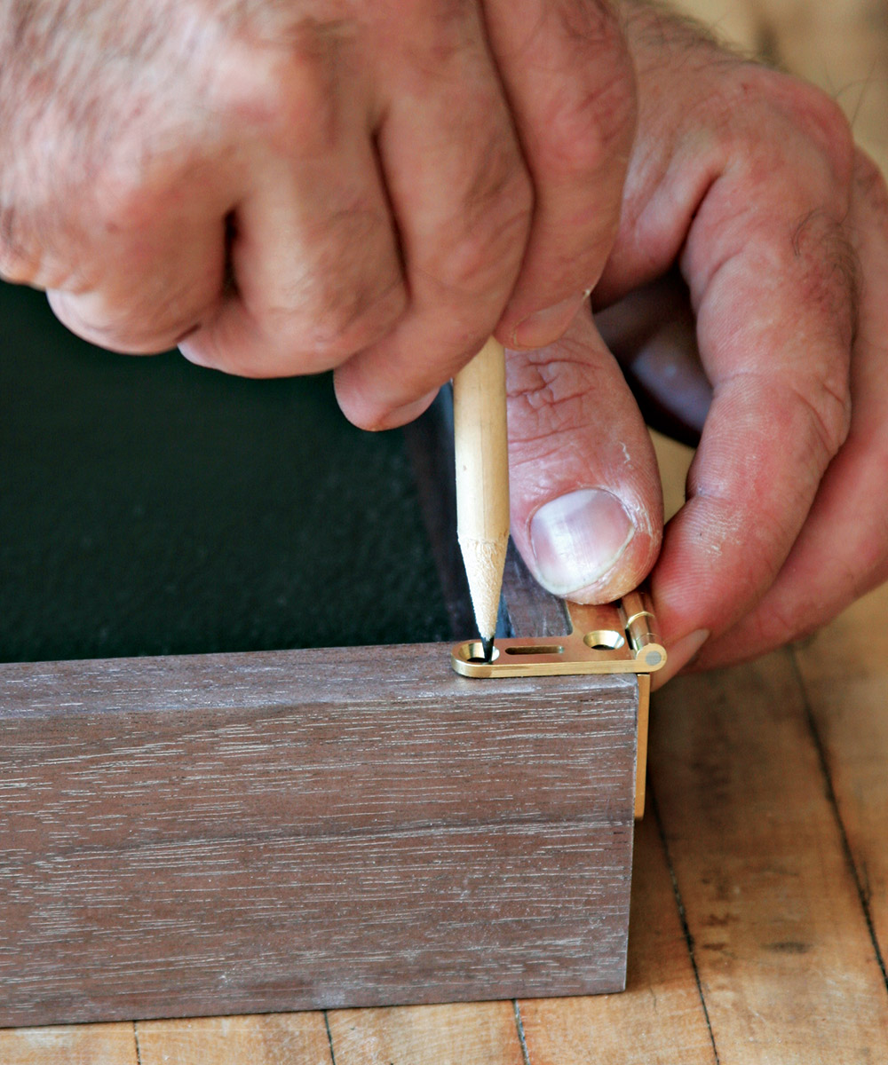 Mark the locations for the hinge screws