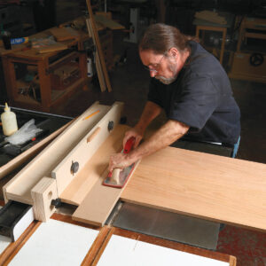 Run the piece so the straightedge rides on the L fence, and the panel is cut along the line.