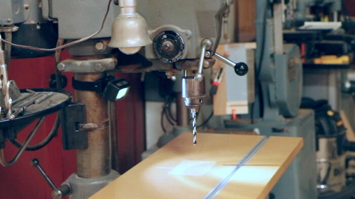 a headlamp mounted the the pillar of a drill press