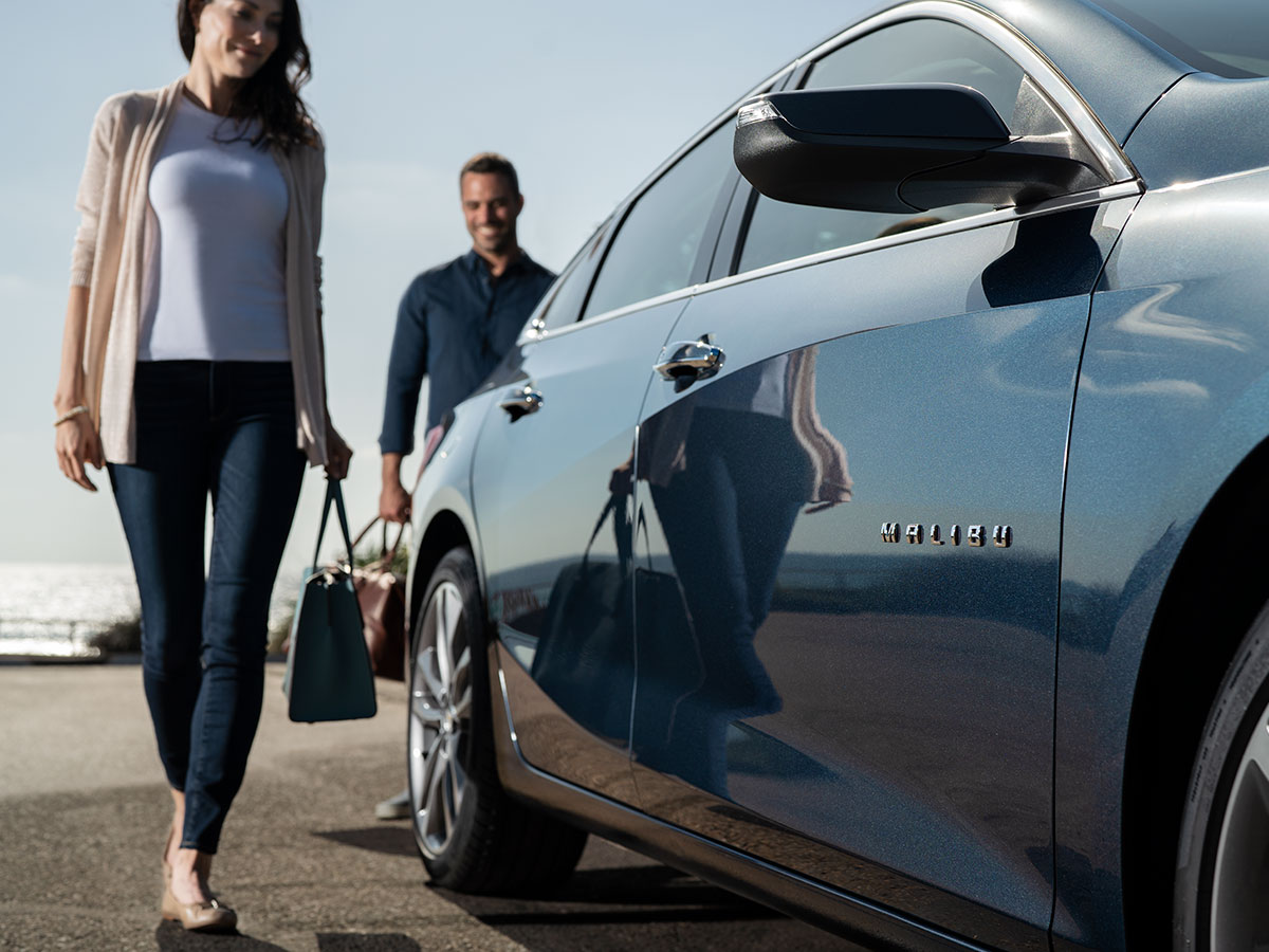 Women walking up to a Malibu after receiving springtime service from Feldman Chevrolet.