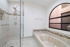 Frameless shower door and tub, al lupdated finishes.