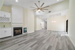 Family room view of a real fireplace, wetbar and wine cooler.