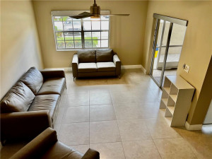 Loving room with sliding doors to screened in patio