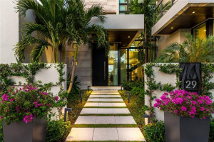 Courtyard entry bookended by Lush landscaped accoutrements.