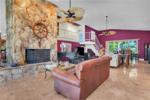 view of the fireplace looking to the sliders in the dining area.