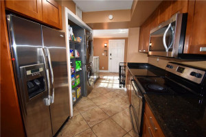 Photo for 3185 Coral Springs Drive, 127, Coral Springs, FL 33065 - Listing #FX-10310779 Galley kitchen leading out to the car port