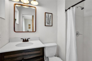 3/4 en suite with updated cabinet, toilet, mirror and light. 3/4 en suite with updated cabinet, toilet, mirror and light.