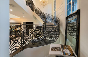 Black metal railings going up the stairs.