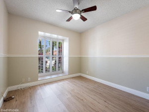 Large second bedroom with plantation shutters is light, bright and nuetral