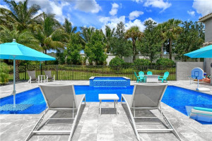 Across pool toward jacuzzi. Notice table and seating in pool