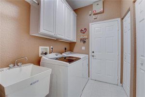 Inside laundry room with Kenmore high efficiency washer & dryer.