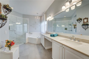 Updated owner's bath with double vanities. Sip a cool drink in your soaking tub.