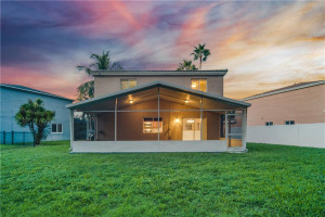 Night Shot Of Back Of Home Showing Off Yard & Screened-In & Covered Patio Area Perfect For Entertaining Night Shot Of Back Of Home Showing Off Yard & Screened-In & Covered Patio Area Perfect For Entertaining