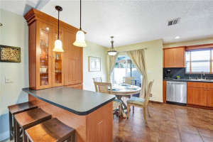 Photo for 10630 NW 16th Street, Coral Springs, FL 33071 - Listing #FX-10355959 ENTRANCE INTO THE LARGE EAT-IN KITCHEN AND SNACK BAR LEADING OUT TO YOUR PRIVATE OPEN AIR PORCH