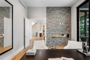 View from office toward living space; double sided gas fireplace.