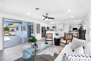 Living space featuring sliders, view to outdoor oasis & kitchen