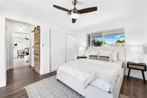 Primary bedroom is located off the living room & split from the other 2 rooms. Featuring 2 closets and wood accent barn door to primary bath.