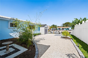 Fully fenced xeriscaped side yard with shed
