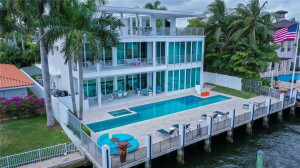 Back elevation, pool, patio and 80 ft concrete dock