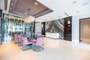 Elegant dining with wine coolers and decorative wine wall.