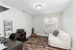 Bedroom 3/office has ceramic plank flooring and custom closet.