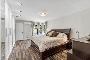 Primary bedroom has a sliding glass door to pool and patio.
