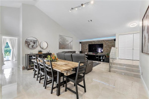 Dining room under the smooth, soaring ceiling.
