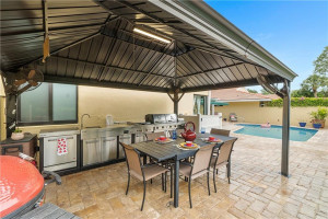 SUMMER Kitchen with double grill, side burner, refrigerator, and sink.