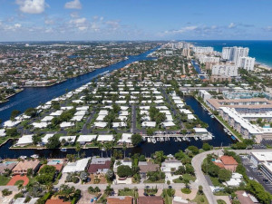 White roofed Palm Club homes with marina shown as well as the Intracoastal Waterway and 2 side canals