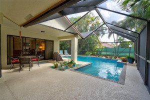 The large size of the lanai provides ample space for outdoor furniture & entertaining, while the L shape of the rectangular pool adds an interesting visual element. The large size of the lanai provides ample space for outdoor furniture & entertaining, while the L shape of the rectangular pool adds an interesting visual element.
