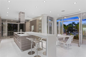 Modern Poggenpohl kitchen exits to the side path and backyard for multiple points of entry.