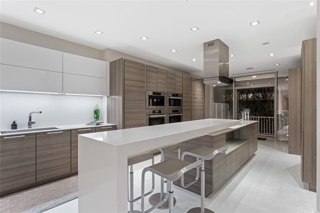 Modern Poggenpohl kitchen exits to the side path and backyard for multiple points of entry.