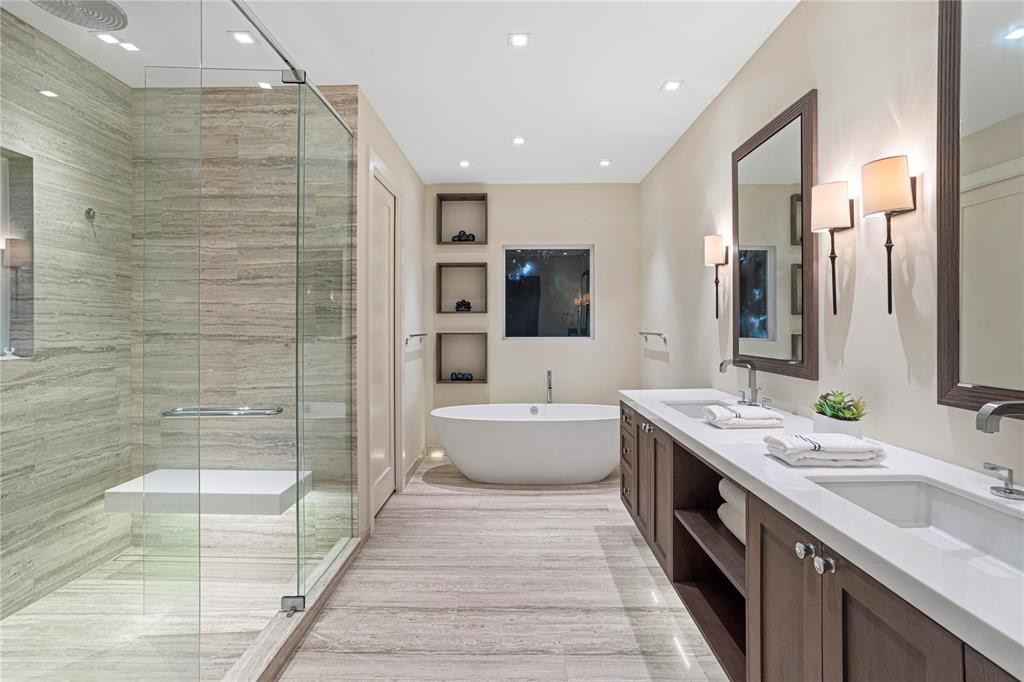 Primary spa bathroom complete with tub and shower.