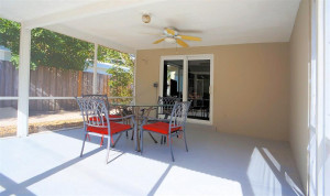 Covered, screened patio for entertaining by the pool.