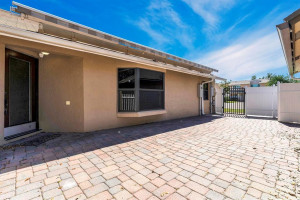 Side area w/ pavers, lighting , gas pipe hookups & retractable awning for your outdoor living